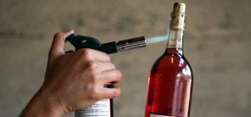 How to open a bottle of wine without a corkscrew with a flame.