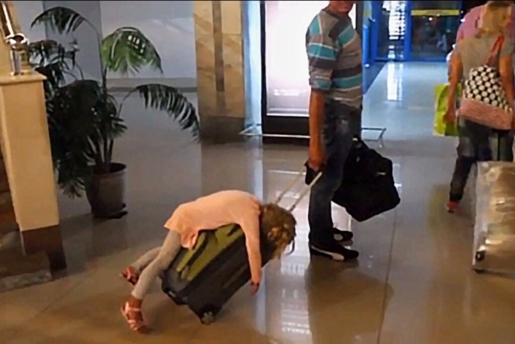 Kids fall asleep in funny places and positions girl sleeps on suitcase