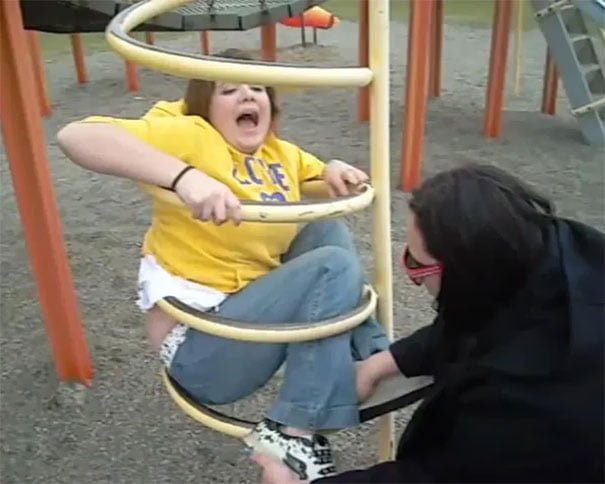 Funny woman got stuck in the children playground