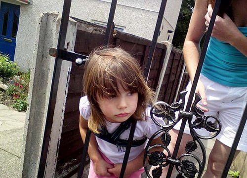 Hilarious kid gets stuck in fence