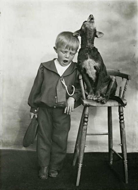 old black and white photo of child and pet dog