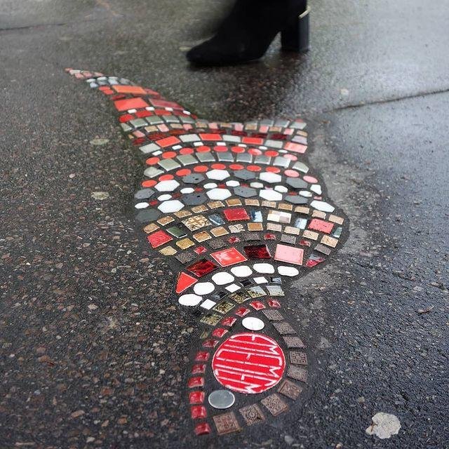 pothole filled with mosaic street art