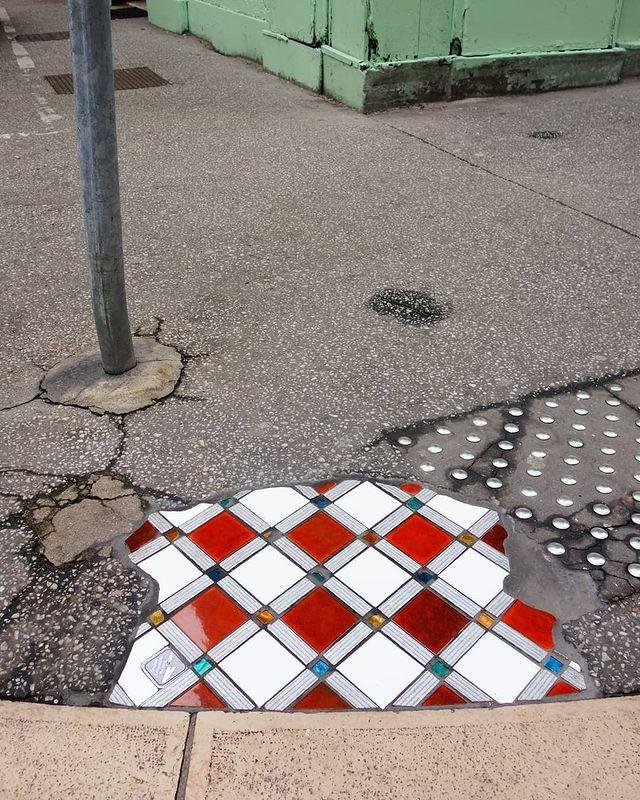 pothole filled with mosaic street art